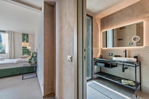 a bathroom with a sink and a mirror at Villa Artista in Gardone Riviera
