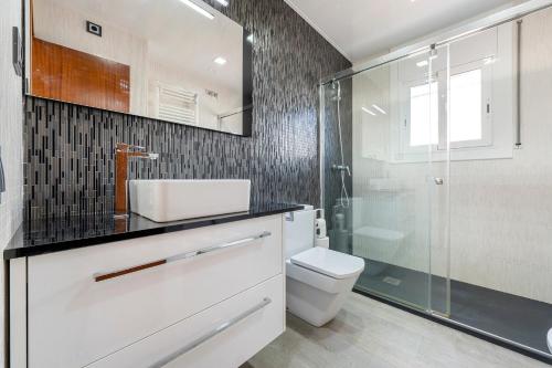 a bathroom with a toilet and a glass shower at Creixell in Creixell
