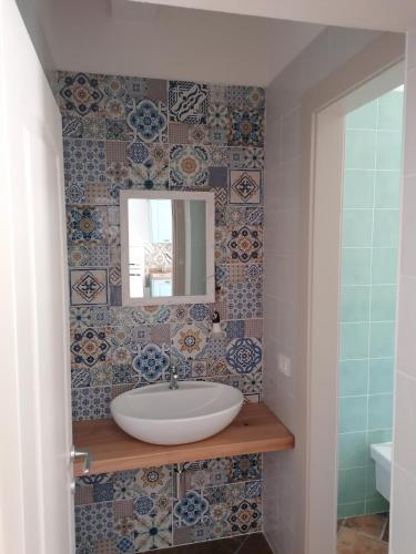 a bathroom with a sink and a mirror at Il Rosmarino in Marciana