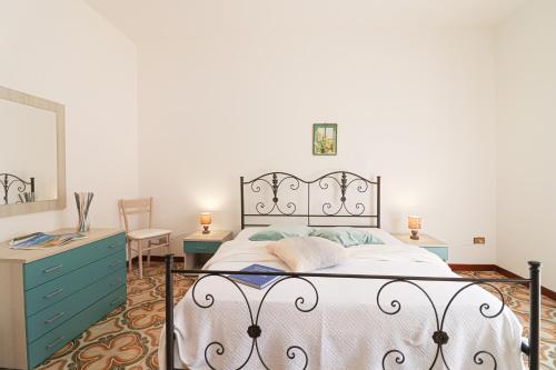 a bedroom with a bed and a dresser and a mirror at Casa Isabel a Otranto 10 posti in Otranto