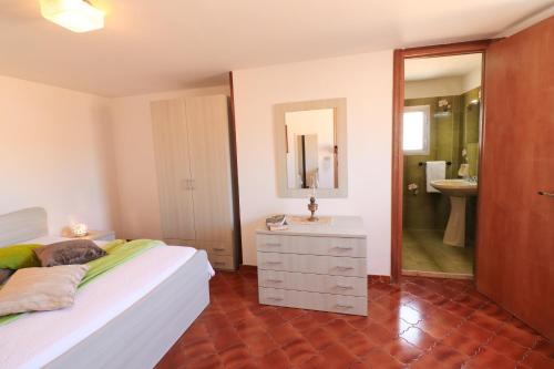 a bedroom with a bed and a sink and a mirror at Casa Isabel a Otranto 10 posti in Otranto
