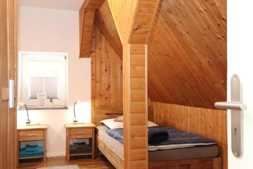 a bedroom with a bed in a wooden room at Ferienwohnung Blum in Schmallenberg