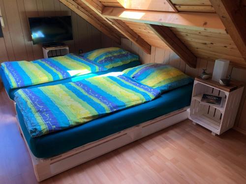 a bed in a small room in a attic at Ferienwohnung Borkum in Burhave