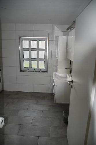 a bathroom with a toilet and a window at Casa Schrader in Kaltenholzhausen