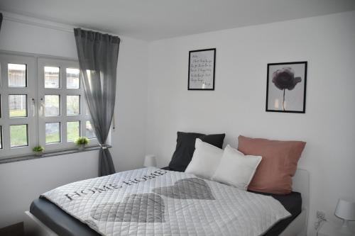 a bedroom with a bed with pillows and a window at Casa Schrader in Kaltenholzhausen