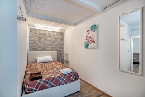 a small bedroom with a bed and a mirror at Casa Giulia Balmuccia in Balmuccia
