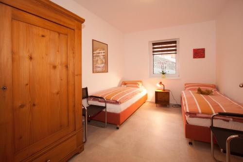 a bedroom with two beds and a window at Ferienwohnung Mertens in Schmallenberg