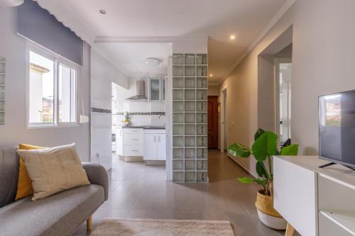 a living room with a couch and a tv at Málaga Dream Apartment in Málaga