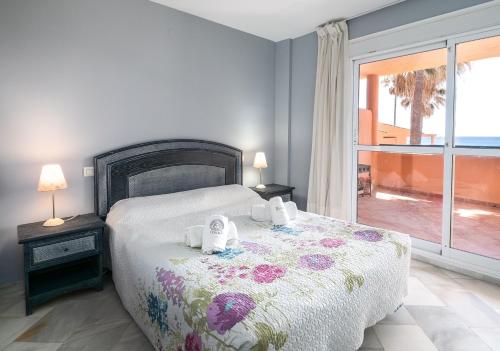 a bedroom with a bed with two teddy bears on it at Fantastic beachfront apartment in Estepona