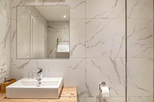a bathroom with a white sink and a mirror at Ferienwohnung Grubig in Ehrwald