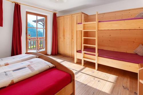 a bedroom with two bunk beds and a ladder at Ausser Brugghof in Senales