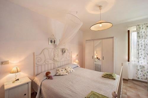 a bedroom with a bed with a teddy bear on it at Casa dei Fiori in Casanova Lerrore
