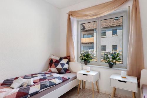 a small bedroom with a bed and a window at Casa Conte in Mörlenbach