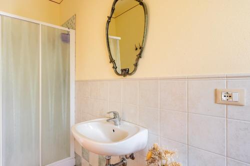 a bathroom with a sink and a mirror on the wall at Casolare dei Fiori - Calla in Montecarlo