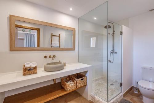 a bathroom with a sink and a glass shower at Sa Vinya Jove in Biniali