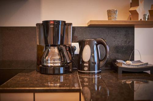 a coffee maker sitting on a counter in a kitchen at Appartements Der Fuchsbau in Saalbach Hinterglemm
