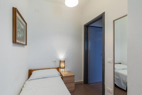 a bedroom with a bed and a mirror at Residence Caravel 9 in Lido di Camaiore