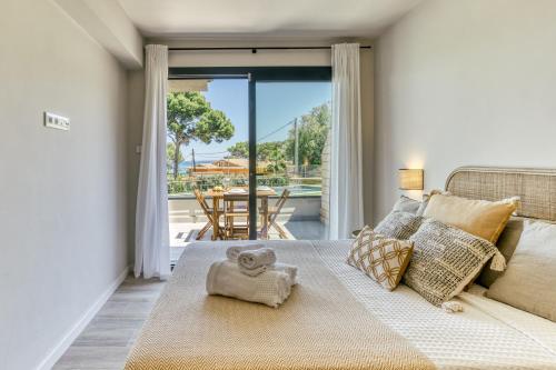 a bedroom with a bed with a teddy bear on it at Bonavista Begur in Begur