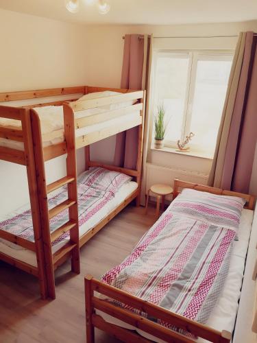 two bunk beds in a room with a window at Ostseeperle Karlina in Karlshagen