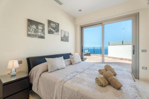 a bedroom with a bed with a view of the ocean at Stunning Casa Bella Vista in Adeje
