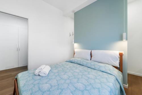 a bedroom with a bed with a pair of shoes on it at 4 Seasons Apartment in Guspini