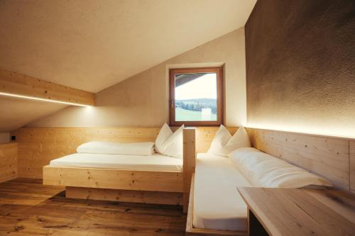a room with two beds and a window at Obertimpflerhof Wohnung Lola in Verano