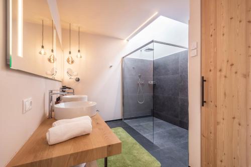 a bathroom with a sink and a shower at Aura Chalets - Nr 1 in Castelrotto