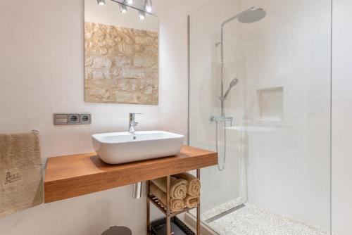 a bathroom with a sink and a shower at Es Campanar in Santanyi