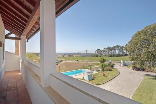 a view from the balcony of a house with a swimming pool at Melquites Country House in Barrantes