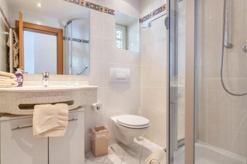 a bathroom with a toilet sink and a shower at Voglsang - Haus Annamirl in Bayrischzell