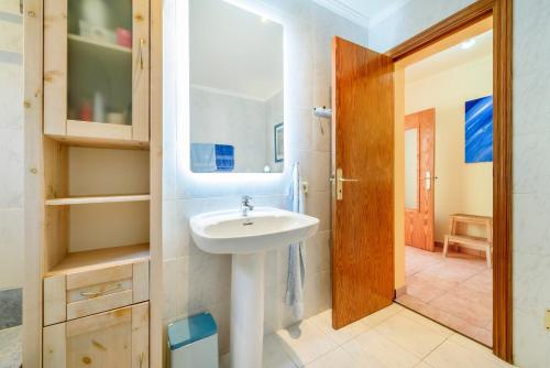 a bathroom with a sink and a mirror at Casa Folara in Cala Llombards