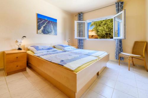 a bedroom with a bed and a window at Casa Folara in Cala Llombards