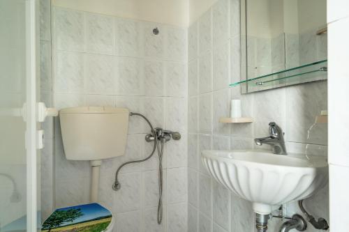 a bathroom with a sink and a toilet at Angela partial sea view 5 in Kefallonia