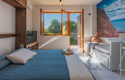 a living room with a bed and a window at Mono Le Lecce 38b in Capoliveri