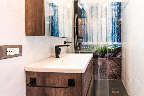 a bathroom with a sink and a shower at Mono Le Lecce 38b in Capoliveri