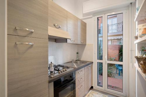 a kitchen with a sink and a stove top oven at Alassio Mare E Non Solo 2 in Alassio