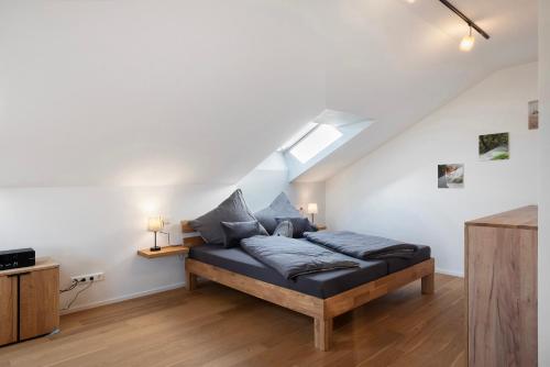 a bedroom with a bed with blue pillows at Waldglück Apartment in Feldberg