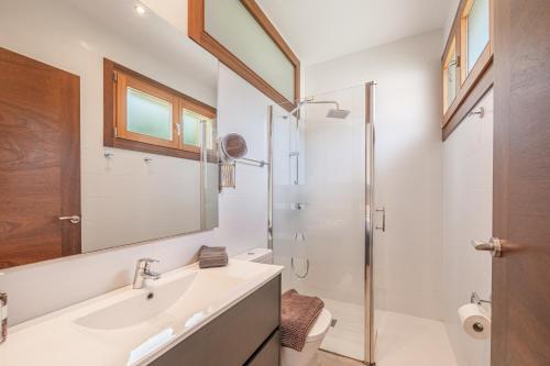 a bathroom with a sink and a shower at Villa Sa Olivera in Crestatx