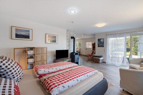 a bedroom with a large bed and a living room at Ferienwohnung Weitblick in Sasbachwalden