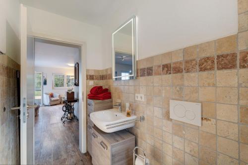 a bathroom with a sink and a mirror at Ferienwohnung Weitblick in Sasbachwalden