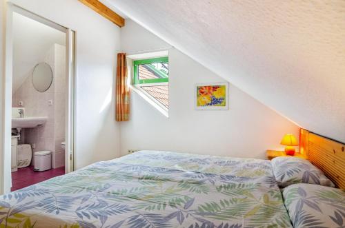 a bedroom with a bed and a window and a sink at Bodenseeblick in Meersburg
