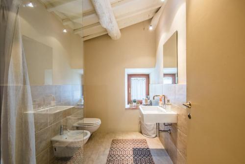 a bathroom with a toilet and a sink and a shower at Brotes Appartamento Mandorlo in Sovicille