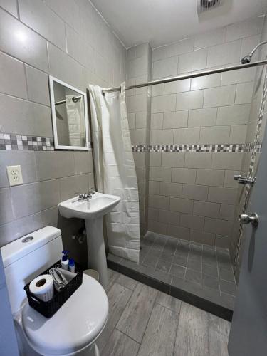 a bathroom with a shower and a toilet and a sink at Departamento privado in Tijuana