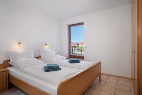 a bedroom with a large bed with towels on it at Gästehaus Heinemann - Og4 in Langenargen