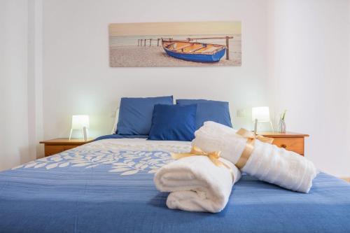 a bedroom with a blue bed with a towel on it at Apartamento Las Playitas in Tuineje