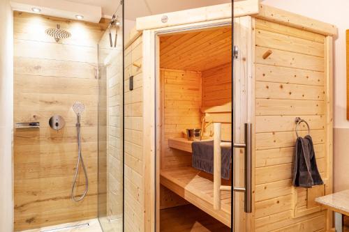 a shower in a wooden bathroom with a shower stall at Maierhof 341 in See
