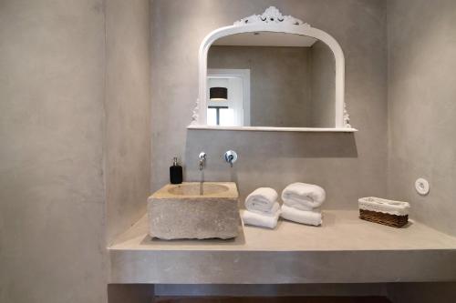 a bathroom with a sink and a mirror at Casa Loulé in Loulé