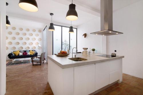 a kitchen with a sink and a counter top at Casa Loulé in Loulé