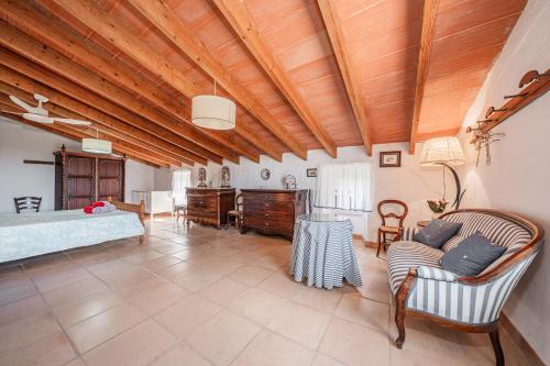 a living room with a bed and a couch at Ca S'hereu in Felanitx
