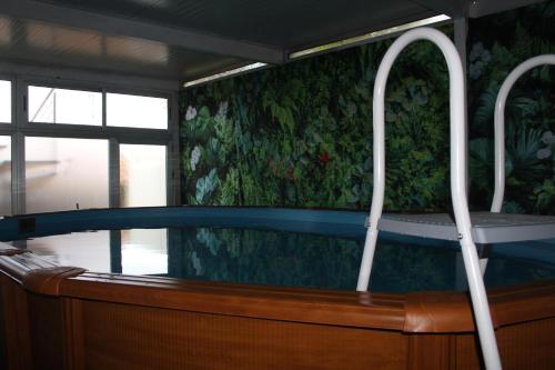 a bath tub in a room with a window at D'ouro Prestige Relax in Sanfins do Douro